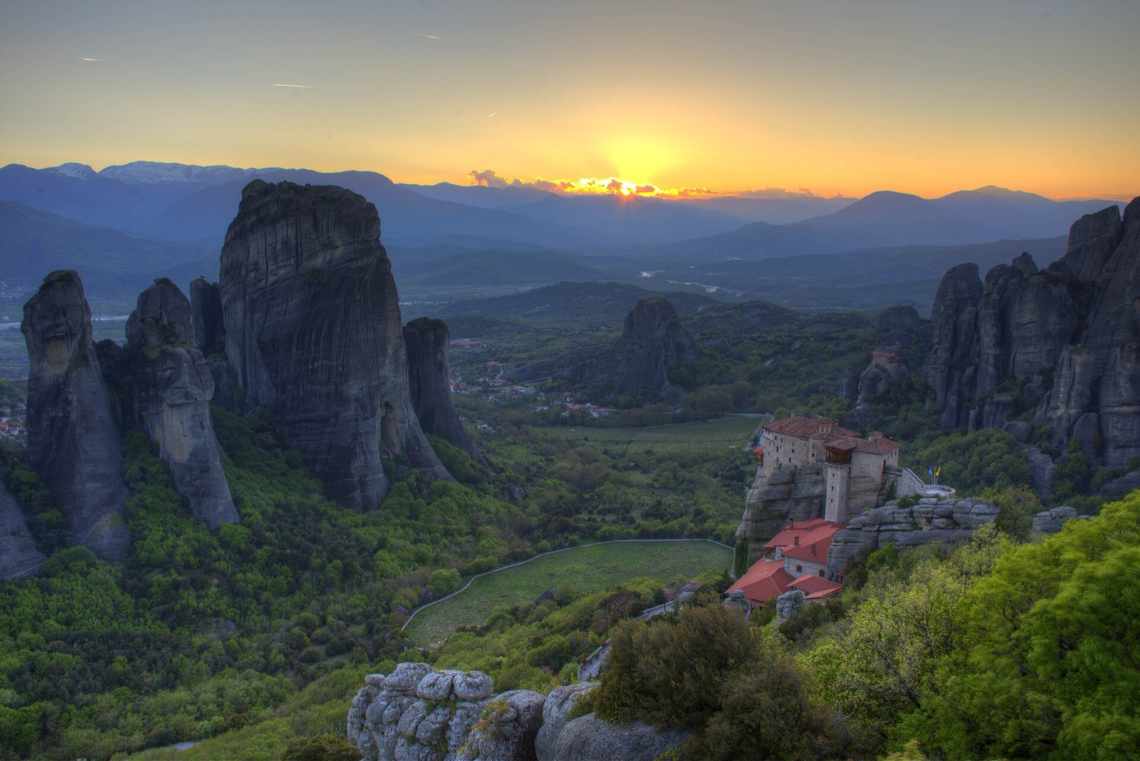 Sunset over the Meteora pillars — evenings stay outdoors, not in clubs